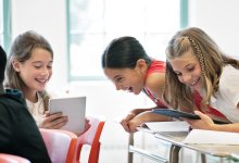 Middle school students happily working together in class