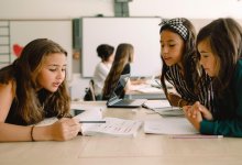 Three middle school students working together in class