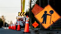 Road construction sign and orange cones