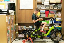 Photo of a student reading while peddling e-bike in class