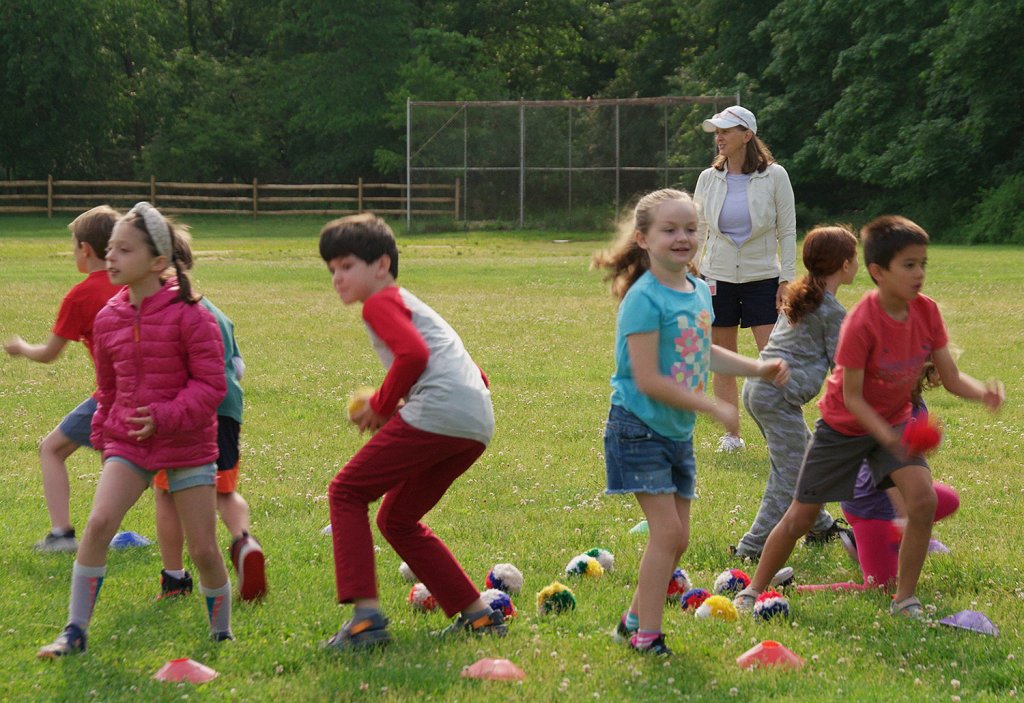 Photo of Ms. Gallagher's second grade students participating in the Buddies activity outside on school field
