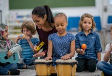 Elementary teacher and students playing a variety of instruments