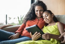 Mother and daughter looking at a tablet together