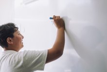 Student writing on whiteboard