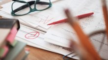 Photo of a pile of graded papers on desk