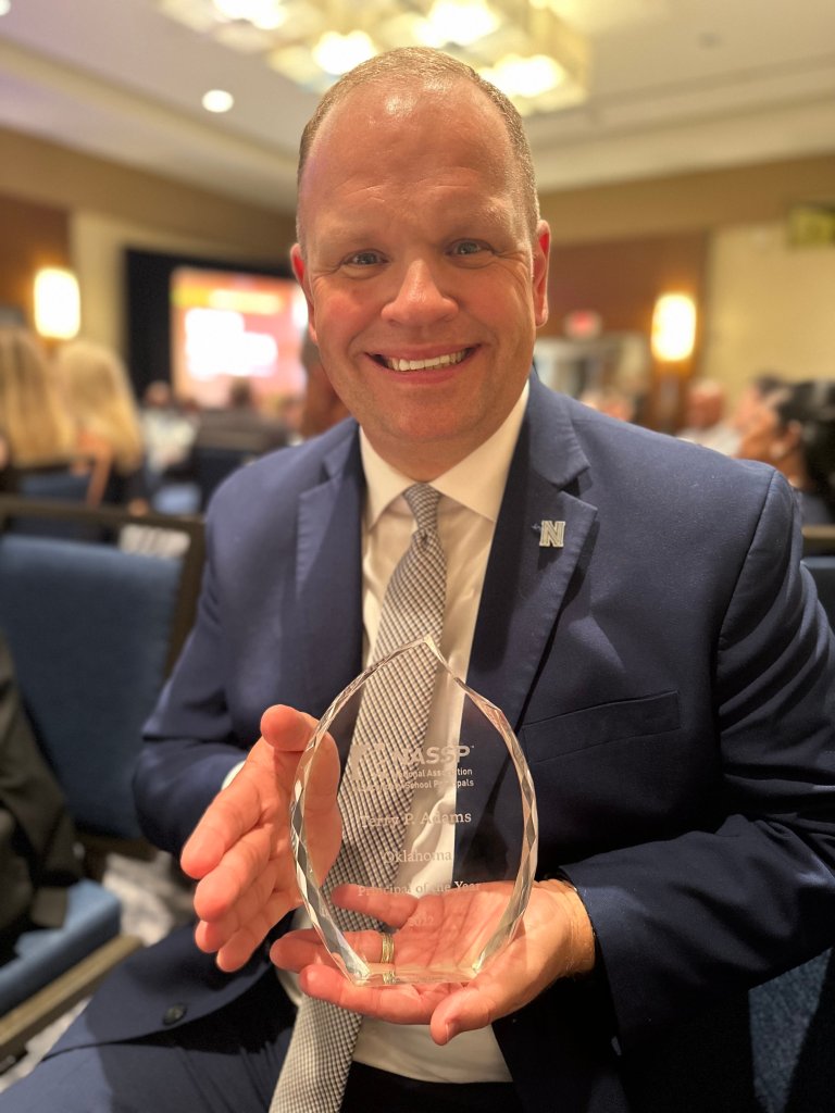 Terry Adams holding award