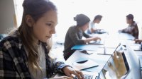 Photo of high school students on laptops