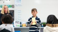 Photo of elementary school student in front of class