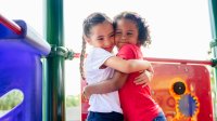 Photo of two elementary students hugging