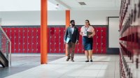 Educators walking down a hallway
