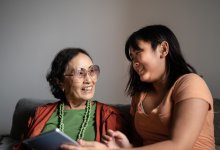 Photo of grandmother and granddaughter talking
