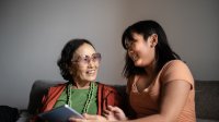 Photo of grandmother and granddaughter talking