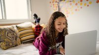 Photo of teen girl at laptop at home