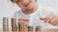 Photo of child making stacks of coins