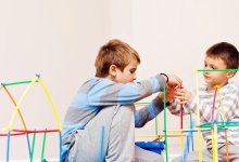 Photo of two students building structure