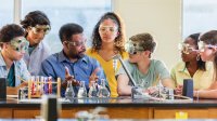 Teacher and students in high school science classroom