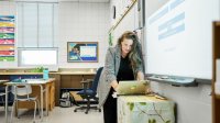 Photo of teacher working with tech in classroom