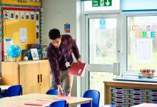 Photo of teacher setting up classroom