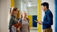 Teacher talking with parent and student