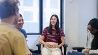 Photo of high school students talking in a circle