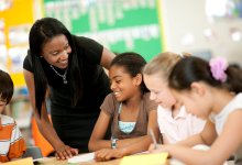 Photo of middle school teacher speaking with students