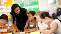 Photo of middle school teacher speaking with students