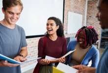 Students talking and moving in a classroom