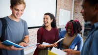 Students talking and moving in a classroom