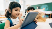 Elementary students using tablets in class