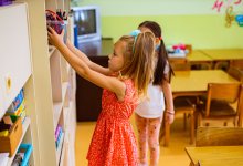 Elementary student putting away supplies in class