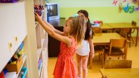 Elementary student putting away supplies in class