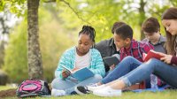 Photo of middle school students reading outside