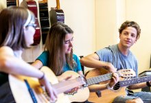 Photo of high school students playing guitars