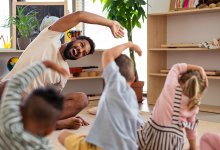 Photo of elementary school teacher stretching with students