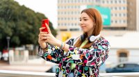 Photo of teenager taking selfie outside