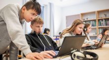 Photo of middle school students working on computers