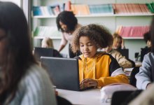 Photo of middle school students working on computers in classroom