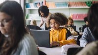 Photo of middle school students working on computers in classroom