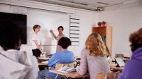 Photo of high school students giving presentation to class