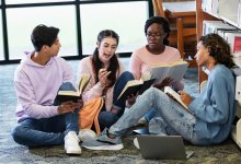 High school students reading books together