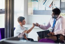 Teacher and student bumping their fists together