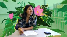 Student working on test with flowers blooming in stages around them