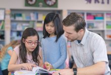 Photo of elementary school teacher working with students