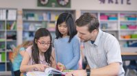 Photo of elementary school teacher working with students