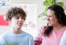 Photo of mother and middle school student at parent teacher conference