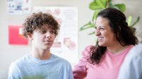 Photo of mother and middle school student at parent teacher conference