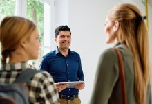 Photo of parent and student meeting teacher