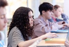 Photo of high school students working on computer in classroom