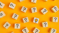 Wood blocks with question marks and a light bulb on them