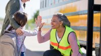 Student giving bus driver a high five
